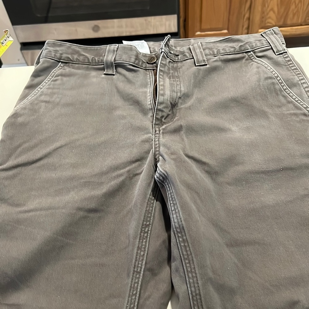 Carhartt mens 33 waist pants. Slightly worn. Warm grayish-brown. Hemmed.